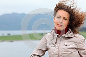 Woman is on board ship and looks into distance