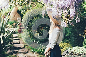 A woman in a boater hat view from the back