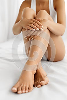 Woman Body Care. Close Up Of Long Legs With Soft Skin And Hands