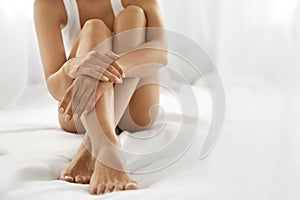 Woman Body Care. Close Up Of Long Legs With Soft Skin And Hands