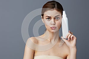 woman body lotion rejuvenation cosmetics Gray background