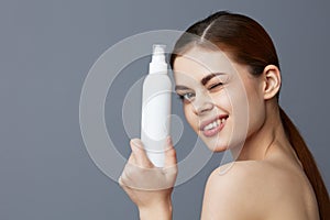 woman body lotion rejuvenation cosmetics Gray background