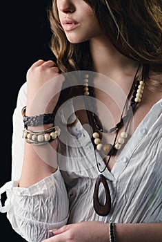 A woman with boho accessories. Bracelet, beads on the model close-up