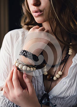A woman with boho accessories. Bracelet, beads on the model close-up