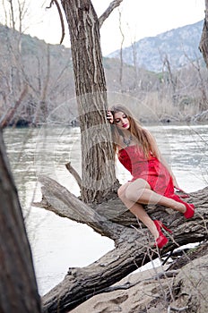 Woman in a bold red dress like a little red riding hood