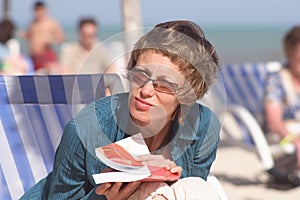 Woman with book on the beach