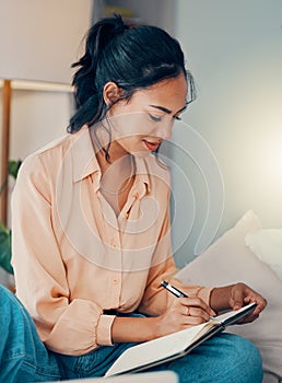 Woman, book and writing on bed for planning, dream or goal in bedroom while home. Girl, notebook and paper with smile