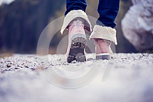 Woman in boots walking along a rural path photo