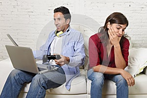 Woman bored and frustrated ignored while internet addict husband or boyfriend using digital tablet networking