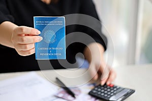 Woman boss gives a brazilian work card and social security blue book to us in employment office