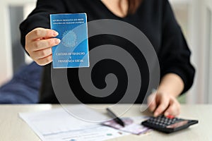 Woman boss gives a brazilian work card and social security blue book to us in employment office