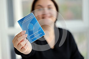 Woman boss gives a brazilian work card and social security blue book to us in employment office