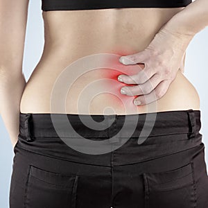 Woman with both palm around back to show pain and injury on back