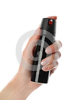 Woman with bottle of gas pepper spray on white background