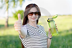 A woman with a bottle of water in her hands