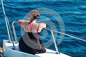 Woman on bow of yacht in Mediterranean sea cruise