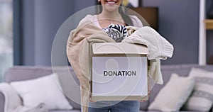 Woman, box and clothes donation for community service for non profit, helping or outreach program. Female person, smile
