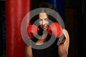 Woman boxer in red gloves