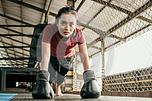 woman boxer wearing black glove do push up when warming up before competing