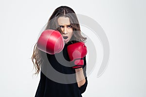 Woman in boxing gloves hitting at camer