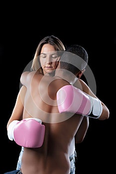 Woman with boxing gloves hugging husband