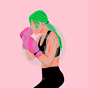 Woman in boxing gloves posing at punching bag in sportswear