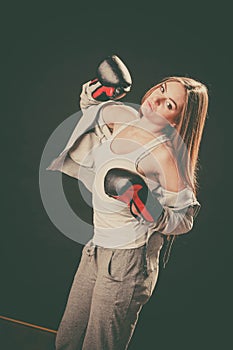 Woman with boxing gloves wear sportswear.