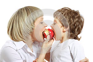 Woman and boy eating apple