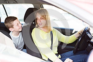 Woman and boy using car during sightseeing tour