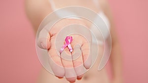 Woman in bra with pink ribbon, breast cancer survivor, pink october, awareness month