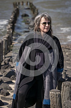 Woman braving the cold day on the coast