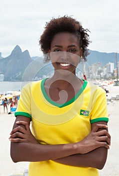 Woman in brazilian jersey with crossed arms at Rio de Janeiro