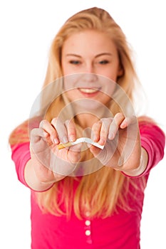 Woman breaking cigarette as a gesture of quitting smoking, break