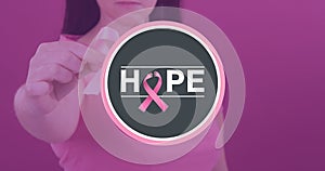 Woman with breast cancer awareness ribbon and hope text against pink background, copy space