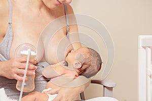 Woman breastfeed baby use breast pump simultaneously photo
