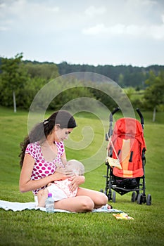 Woman breastfeeding her baby outdoors