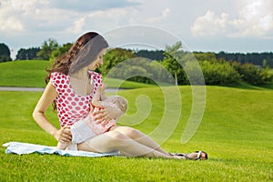 Woman breastfeeding her baby outdoors