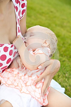 Woman breastfeeding her baby outdoors