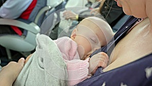 A Woman Breastfeeding her Child on a Plane