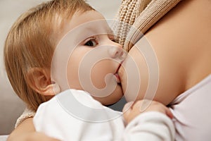 Woman breastfeeding her little baby, closeup