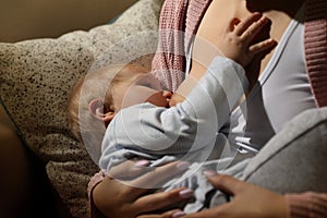 Woman breastfeeding her little baby, closeup