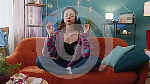 Woman breathes deeply with mudra gesture eyes closed, meditating with concentrated thoughts peaceful