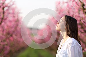 Woman breathing fresh air in a beautiful field