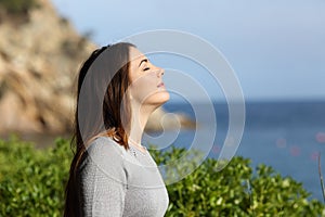 Woman breathing fresh air relaxed on vacation photo