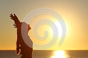 Woman breathing fresh air at sunset