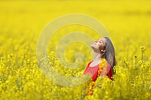 Woman breathing fresh air in a yellow field