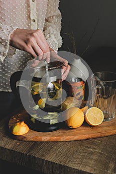 Woman brew citrus tea on a sunny day