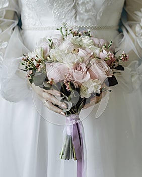 woman with bridal bouquet. eremony wedding day. hands with wedding rings.