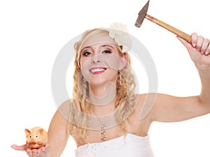 Woman bride with hammer about to smash piggy bank