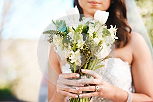 Woman, bride and hands with bouquet of flowers for wedding, marriage or ceremony in outdoor nature. Closeup of female